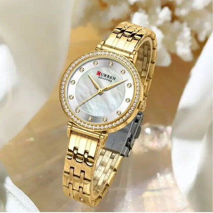 Reloj Curren para mujer 9087, de acero inoxidable dorado plateado con diseño delicado y manecillas precisas. Un accesorio versátil y duradero para cualquier ocasión.